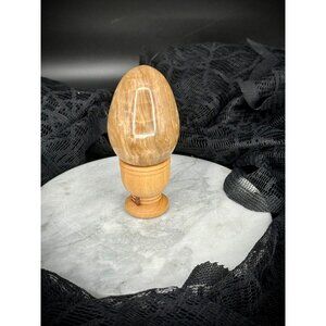 Calcite crystal egg on a wooden stand